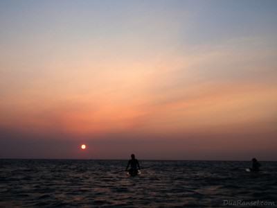 Paddleboarding during sunset in Roatan Island, Honduras