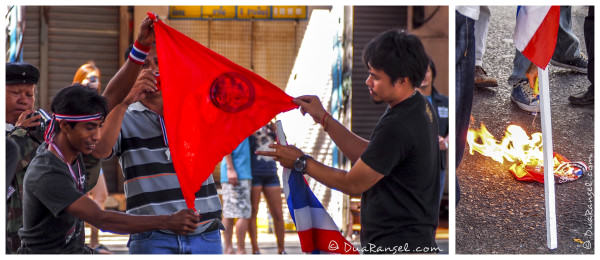 Protesters burning the red shirts flag.